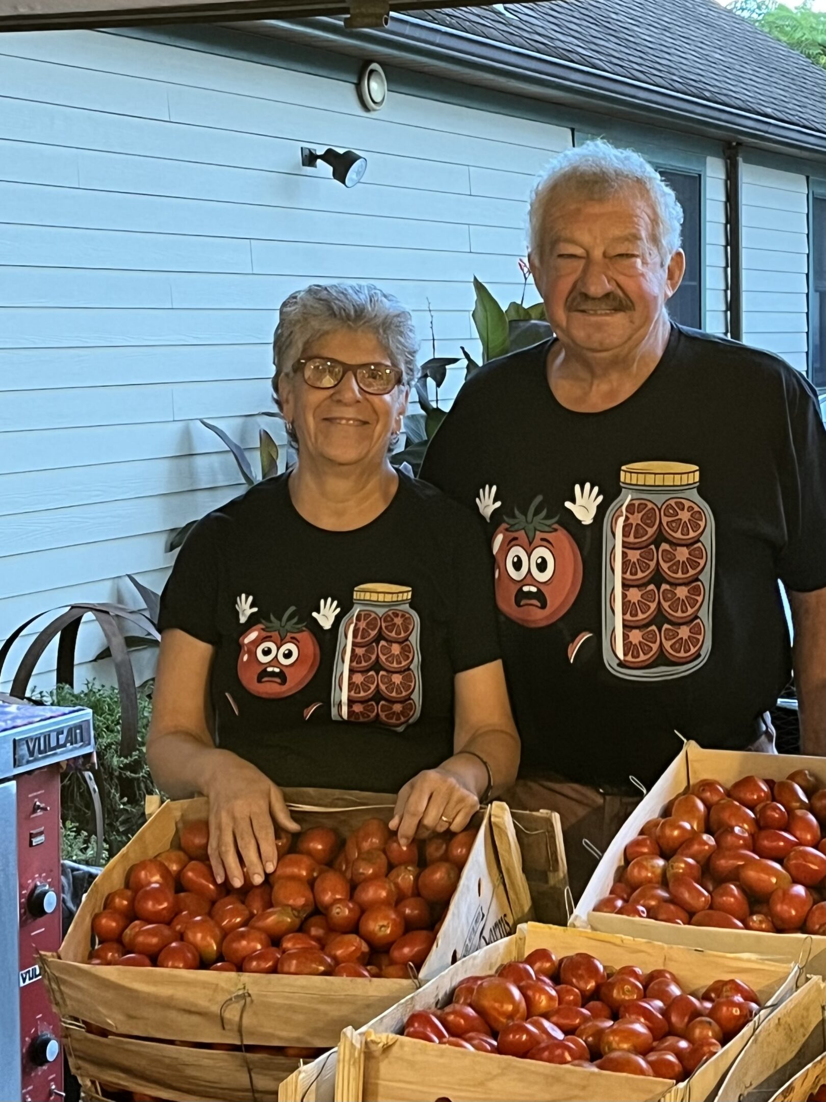 Smiling couple selling garden-fresh tomatoes